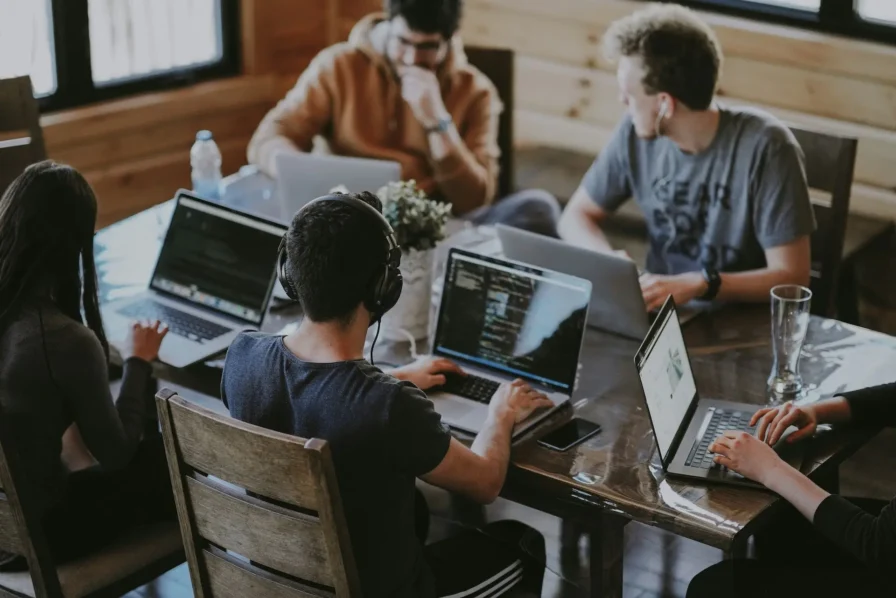 a small business sat around a desk discussing allowances and deductions